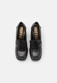 Black leather loafers with a square toe, featuring a smooth texture and a prominent logo in gold on the insole. Elegant and minimal design.