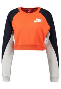 Felpa cropped Nike con corpo arancione, maniche nere e dettagli bianchi. Realizzata in un tessuto dalla texture liscia. Logo sul petto.