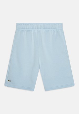Svetlomodré šortky z mäkkej látky, s elastickým pásom, bočnými vreckami a malým zeleným logom na ľavej nohe.