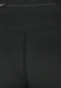 Sorte atletiske leggings med en glat, strækbar tekstur, med en lynlåslomme på bagsiden og forstærket syning langs sømmene.