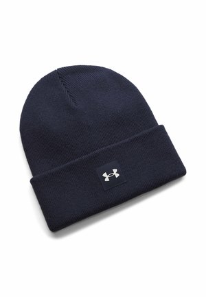 Dark blue knit beanie with a folded brim, featuring a centered white Under Armour logo on a small front patch.