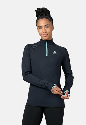 Black long-sleeve performance top with zip collar, light blue accents, reflective details on shoulders, and thumbholes at cuffs.