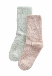 Pluizige sokken in lichtgroen en zachtroze. Pluizige textuur, tot halverwege de kuit, met een geborsteld oppervlak voor extra zachtheid.