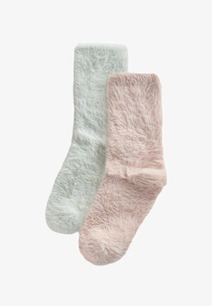 Fluffy socks in light green and blush pink, featuring soft, textured material and a ribbed cuff for comfort.