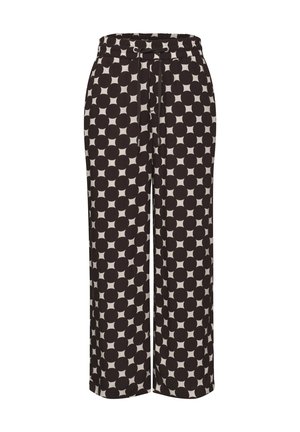 Pantalones de pierna ancha con un patrón grande de lunares en blanco y negro y una cintura elástica con un lazo delantero.