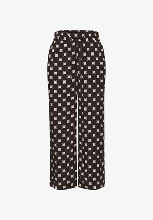 Spodnie o szerokich nogawkach z dużym czarno-białym wzorem w groszki i elastycznym pasem z wiązaniem z przodu.