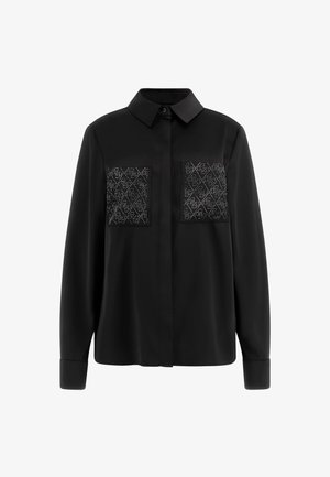 Black shirt with a classic collar and long sleeves. Features two decorative front pockets with a patterned accent, made from smooth fabric.