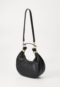 Black leather handbag with a rounded shape, gold hardware accents, and a single adjustable strap. Smooth texture and zip closure.