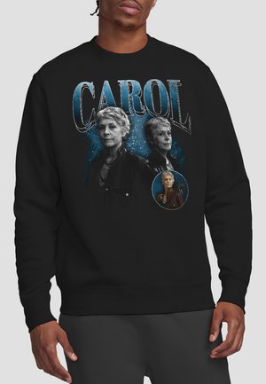 Black sweatshirt featuring two older women portraits with the text "CAROL" above and a smaller inset portrait on a blue textured background.