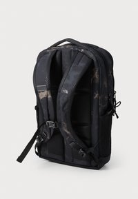 Black camo backpack with padded straps, mesh detailing, adjustable buckles, and textured finish. Features multiple compartments and zippers.