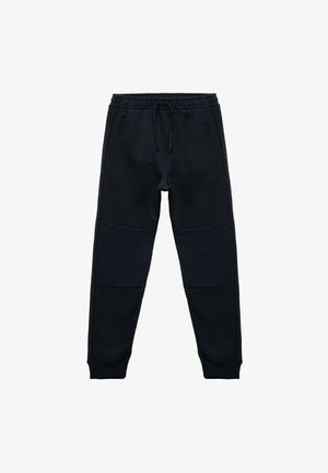 Zwarte joggerpants gemaakt van zachte stof, met een trekkoord in de taille, geribde kniemotieven en aansluitende enkels voor een snugge pasvorm.