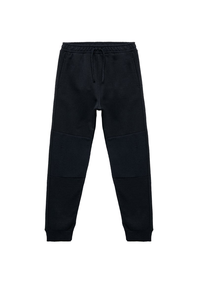 Sorte joggebukser lavet af blødt stof, med snøre i taljen, ribbede knædetaljer og tætsiddende ankelsluttere for en god pasform.