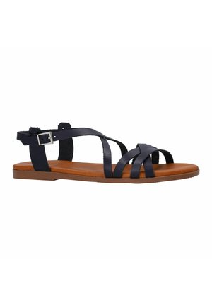 Flat sandals in dark navy leather with multiple crisscross straps. Brown sole, adjustable ankle strap with silver buckle detail.