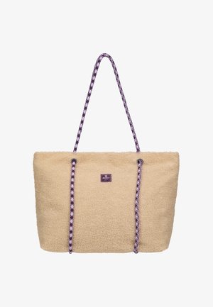 Beige harige draagtas met lange paarse en witte patroon touwen als hengsels en een klein, gecentreerd merklabel aan de voorkant.