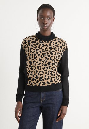 Leopard print sweater with a black ribbed neckline and sleeves. Soft knit fabric, featuring contrasting colors and an oversized fit.