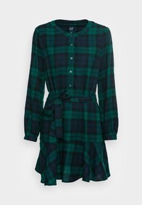 Robe à carreaux verts et bleu marine, manches longues, boutonnée à l'avant, taille cintrée avec un lien, et jupe évasée. En tissu doux avec une finition texturée.