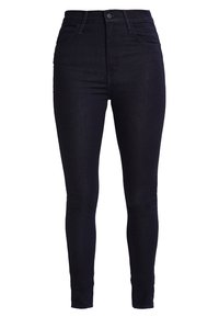 Vaqueros ajustados de cintura alta en denim oscuro, con una textura suave, diseño clásico de cinco bolsillos y detalles de costura mínimos.