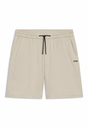 Beige athletic shorts made of breathable fabric, featuring an elastic waistband with a drawstring, and side pockets. Subtle perforated pattern.