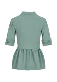 Top verde menta a maniche lunghe con colletto, vita arricciata e maniche ripiegate con dettagli a bottone. Realizzato in un morbido tessuto testurizzato.