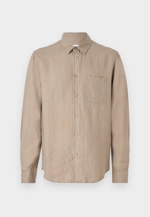 Chemise en lin marron à manches longues avec col pointu, fermeture à boutons, poche poitrine unique et coupe décontractée. Texture douce et design léger.