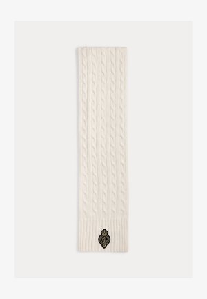 Valge kootud sall palmiku mustriga, mis on varustatud soonikkoes otstega ja musta embleemiga. Valmistatud pehmest tekstuurse viimistlusega kangast.