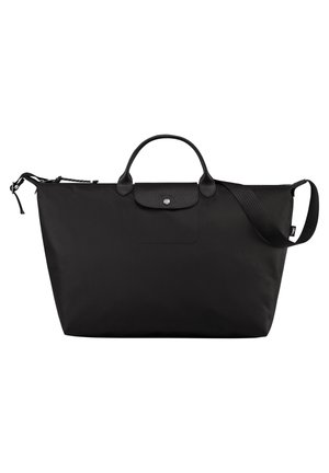 Black nylon tote bag with dual handle and adjustable shoulder strap. Features a front pocket with a snap button closure. Smooth texture.