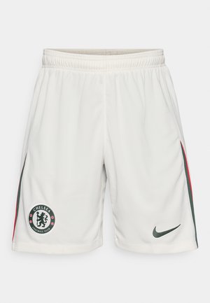 Bele kratke nogavice za nogomet v belem, ki imajo teksturirano tkanino, elastičen pas, logotip Chelsea FC in zelene ter rdeče stranske črte. Logotip Nike na robu.