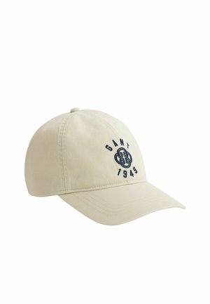 Beige baseballpet met gebogen klep, voorzien van zwart geborduurd "GANT 1949"-tekst en logo op het voorpaneel.