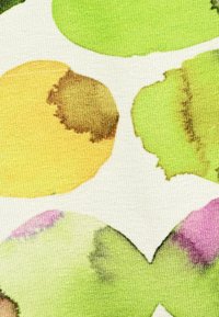 Textile featuring a white background with large, overlapping watercolor circles in yellow, green, and light pink, with varying textures and gradients.