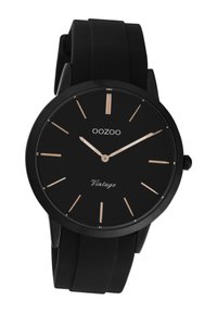 Montre avec bracelet en silicone noir et cadran noir minimaliste, marqueurs d'heure et aiguilles en or rose. Comprend le texte "OOZOO" et "Vintage".