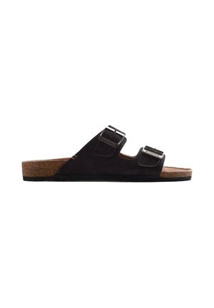 Sandalia negra tipo slide con puntera abierta, suela de corcho y dos correas ajustables con hebillas en la parte superior, mostrada de perfil sobre fondo blanco.