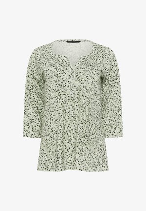 Blusa verde chiaro a maniche lunghe con stampa floreale piccola in bianco e nero, scollo rotondo e quattro bottoni sul davanti.