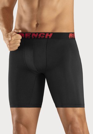 Black men's boxer briefs with a snug fit, made from smooth fabric. Features a red elastic waistband with "BENCH ATHLEISURE" prominently displayed.