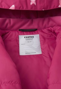 Vaaleanpunainen puhvijakku, jossa on pehmeä vuori, ja jossa on etiketti, jossa lukee "reima". Etiketissä on myös tietoa säänkestävyydestä ja koosta.