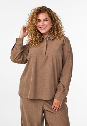 Long-sleeve brown corduroy shirt with a button-up collar and cuffed sleeves, featuring a relaxed fit and a subtle striped texture.