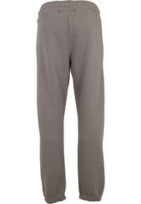 Grå joggebukser med elastisk liv og smale mansjetter. Laget av et mykt, glatt materiale med et enkelt, ensfarget design.