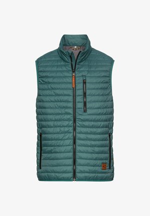 Grønne polstrede veste med høj krave, frontlynlås, to sidelommer og et lille brandlogo i brun læder nederst til højre.