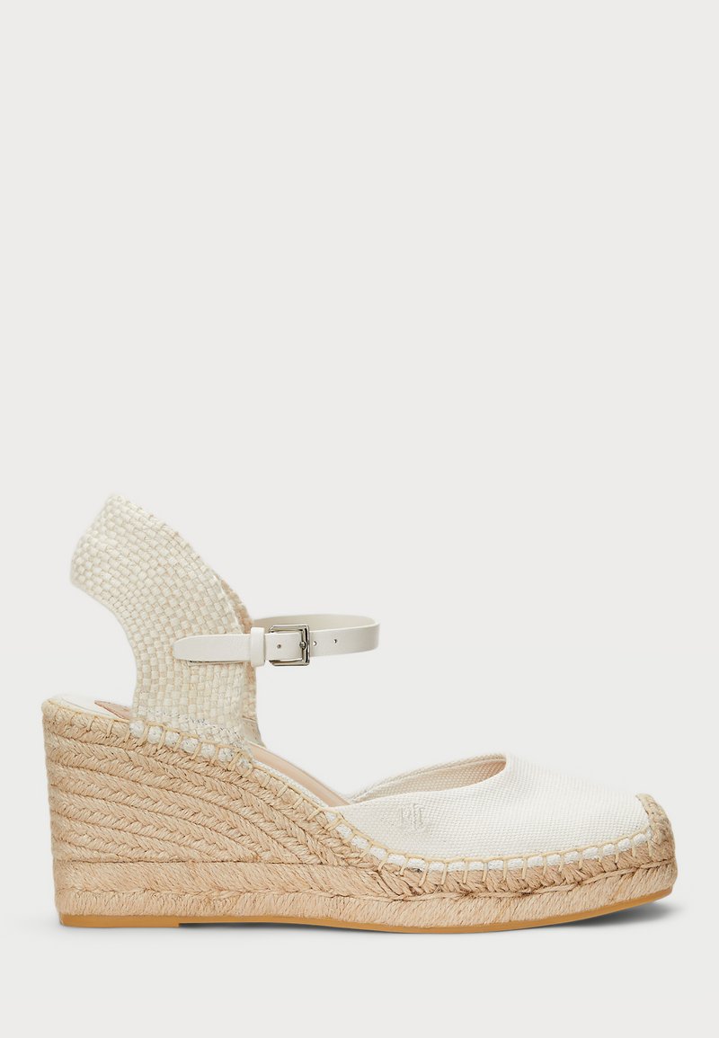 White espadrille wedge sandal with woven upper and ankle strap. Features a jute-wrapped platform and textured outsole. Rounded toe design.