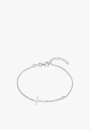Bracelet délicat en chaîne d'argent avec un charme croix horizontale et un petit cristal rond près du fermoir sur un fond blanc.