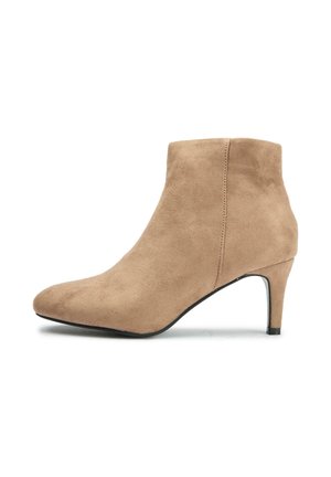 Beige suede ankle boot with a pointed toe and a slender black heel. Features minimal stitching and a smooth, soft texture.