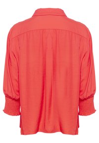 Blusa rossa con colletto, maniche a sbuffo, polsini arricciati e design con piega sul retro. Realizzata in un tessuto leggero e liscio.