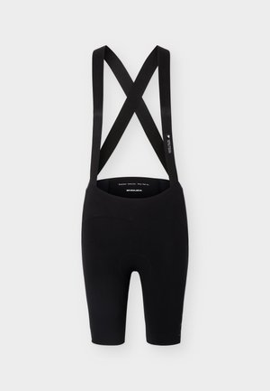Schwarze Radhosen mit gekreuzten elastischen Schulterträgern und gepolstertem Sitzbereich, entworfen für Komfort und Leistung.