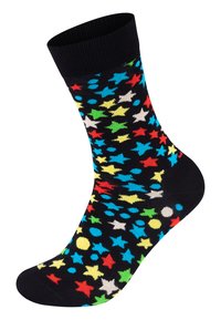 Calze nere con un motivo colorato di stelle e punti in rosso, blu, giallo, verde e bianco, realizzate in un materiale morbido ed elastico.