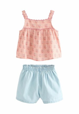 Pink sleeveless top with floral pattern and scalloped trim, paired with light blue elastic-waist shorts. Soft cotton fabric.