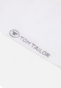 White cotton sock with a smooth texture, featuring a gray "TOM TAILOR" logo printed on the cuff.