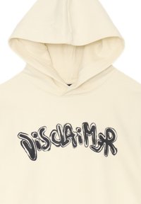 Felpa color crema con un tessuto testurizzato; presenta un grande grafico nero con la scritta "Disclaimer" in un font stilizzato sul davanti.