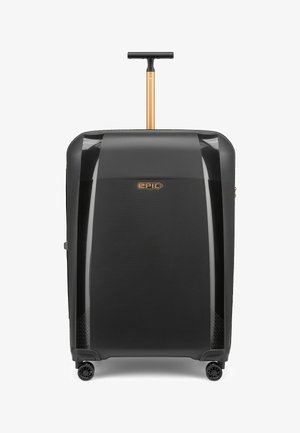 Schwarzer Hartschalenkoffer mit vier Rollen, teleskopischem goldenem Griff und mittig platziertem "EPIC"-Logo auf der Vorderseite.