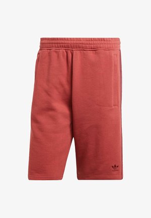 Bermudas atléticas rojas hechas de tejido suave, con una cintura elástica, bolsillos laterales y un pequeño logotipo de la marca cerca del dobladillo.