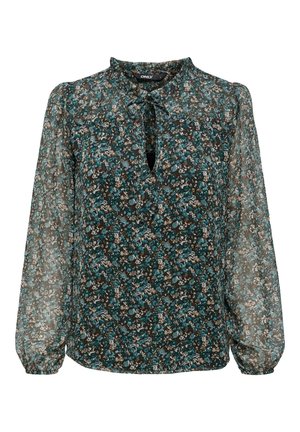 Blouse transparente à manches longues avec poignets froncés, motif floral bleu canard foncé et marron, encolure goutte avec petit nœud devant.