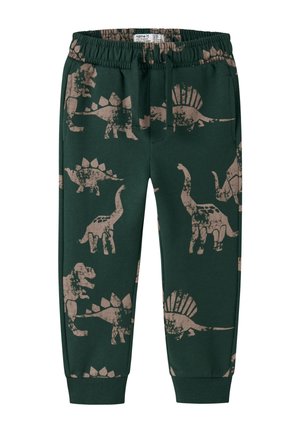 Pantalon enfant vert foncé avec imprimés de dinosaures marron, taille élastique avec cordon, poches latérales et bords-côtes aux chevilles.